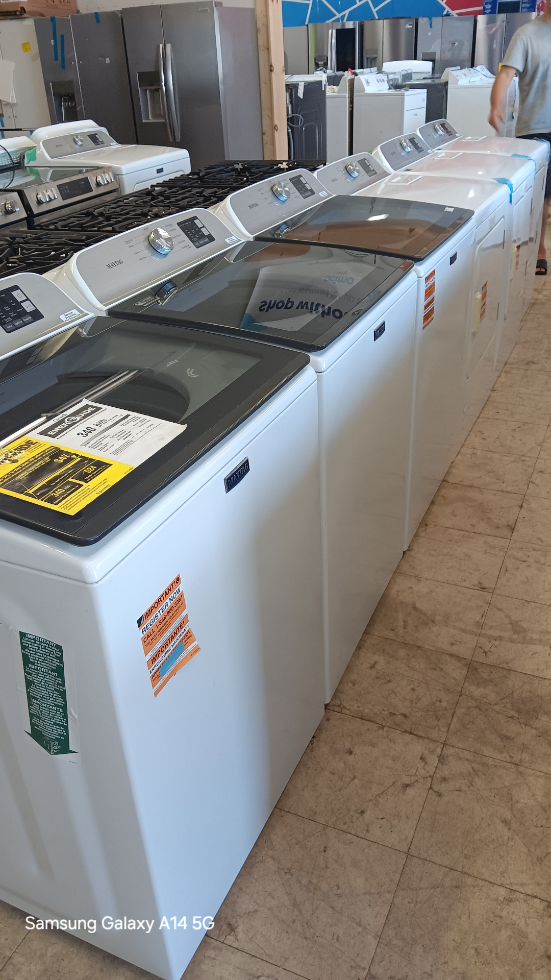 Row of top-load washers on the Appliance Outlet showroom floor