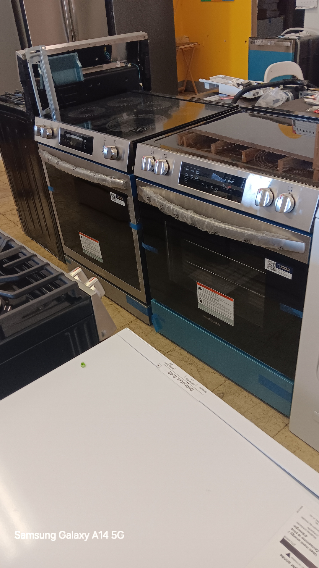 Stainless steel electric ranges on the showroom floor