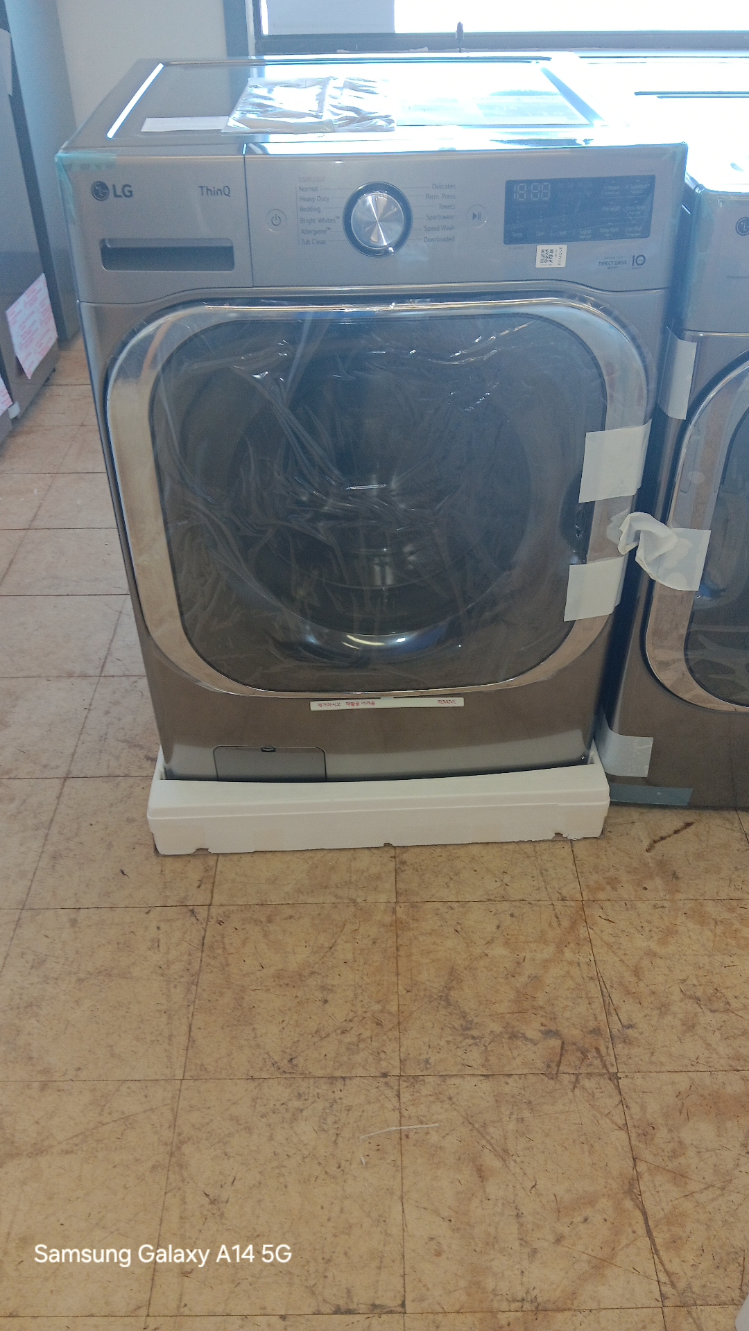 LG ThinQ front-load washer on the showroom floor